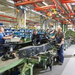 Workers assemble a truck chassis at the Mercedes-Benz Wörth plant.